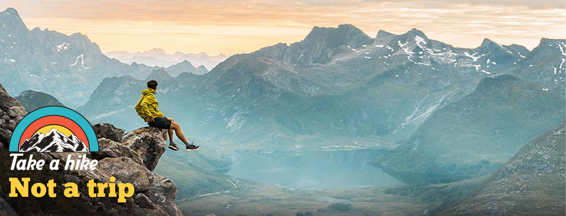 A hiker above a mountain lake, with the original Take a hike, Not a trip artwork